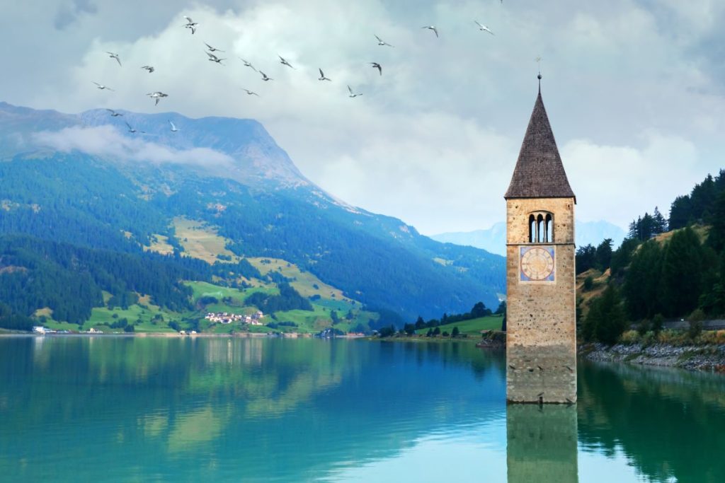 Un clocher d'église au milieu d'un lac.