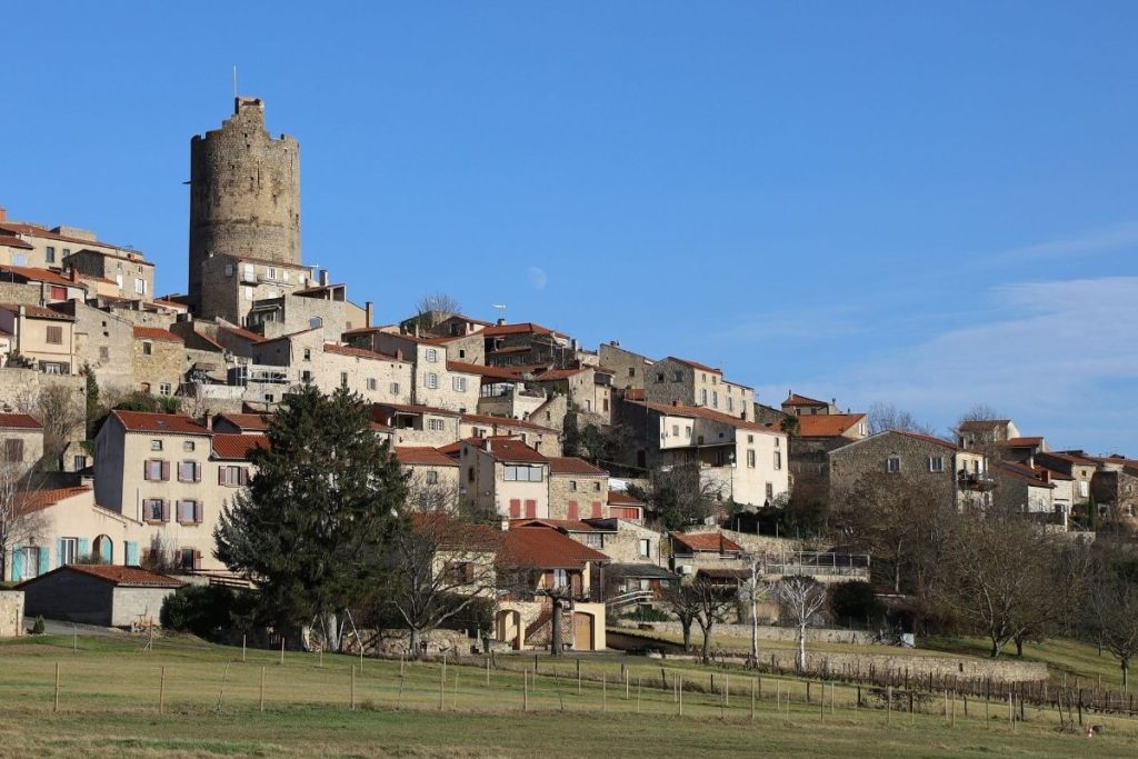 Un village avec une tour au sommet d'une colline.