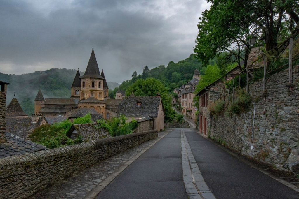 Une rue bordée de bâtiments en pierre et d'une église.