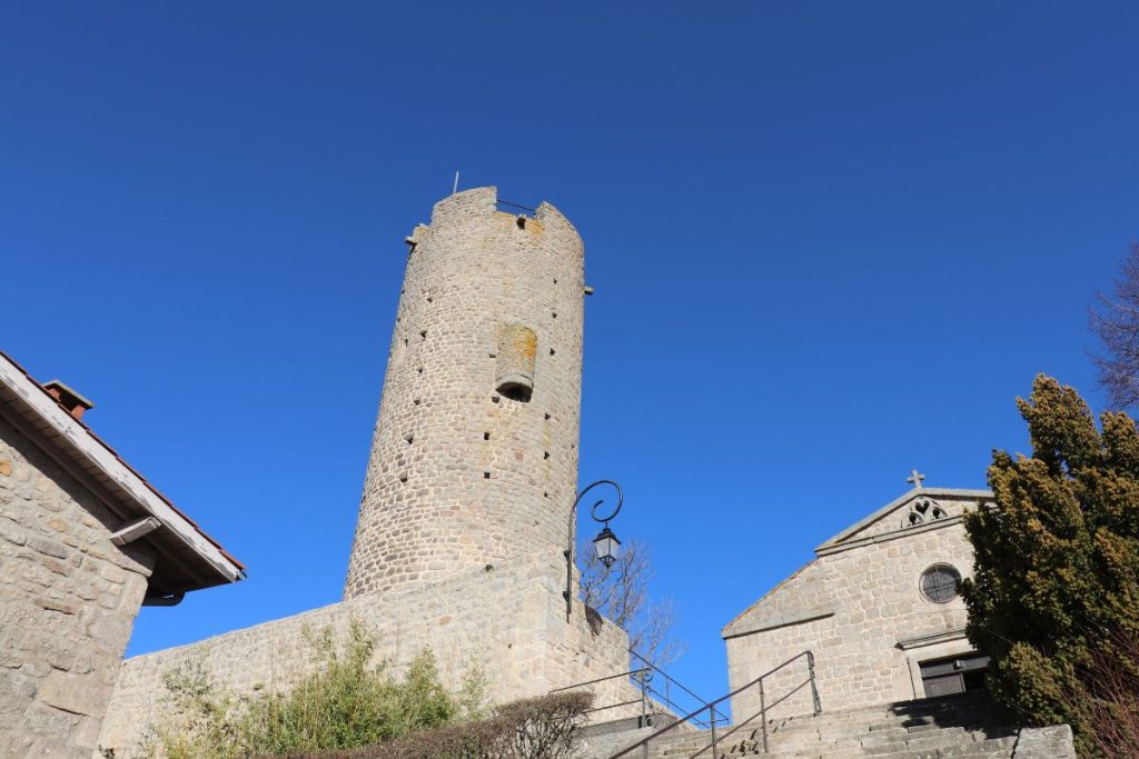 Une tour en pierre à côté d'un bâtiment en pierre.