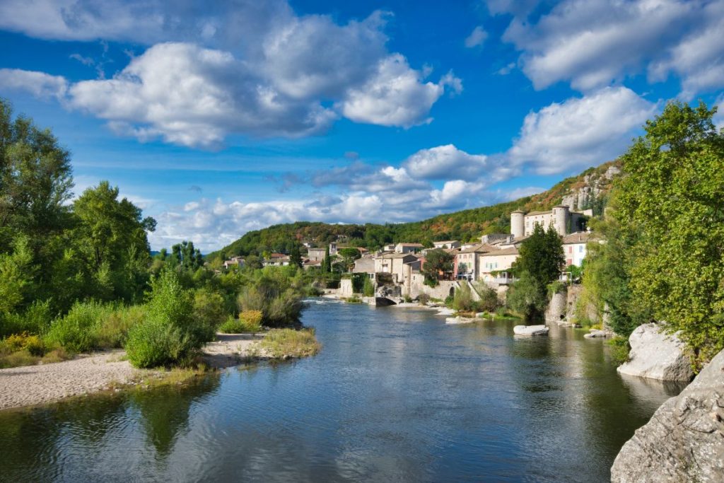 Une rivière traverse une petite ville de France.